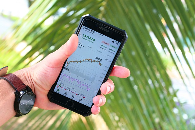 *Stock Market News Today*—A hand holding a smartphone displaying stock market charts and data, symbolizing real-time financial analysis and market updates.