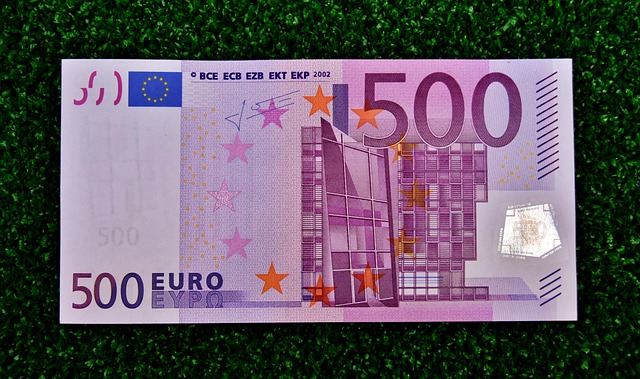A 500 Euro banknote placed on a green surface, symbolizing financial security and the importance of save money wisely.