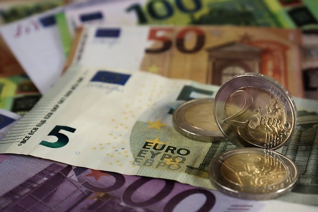 A collection of Euro banknotes and coins, symbolizing financial growth and the 5 stages of wealth accumulation.