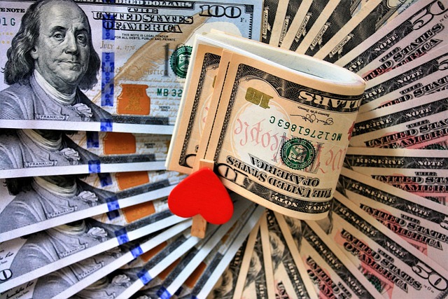 Create My Own Wealth—A fan of hundred-dollar bills with a rolled bundle of notes clipped by a small red heart, symbolizing the balance between financial ambition and personal passion in wealth creation.
